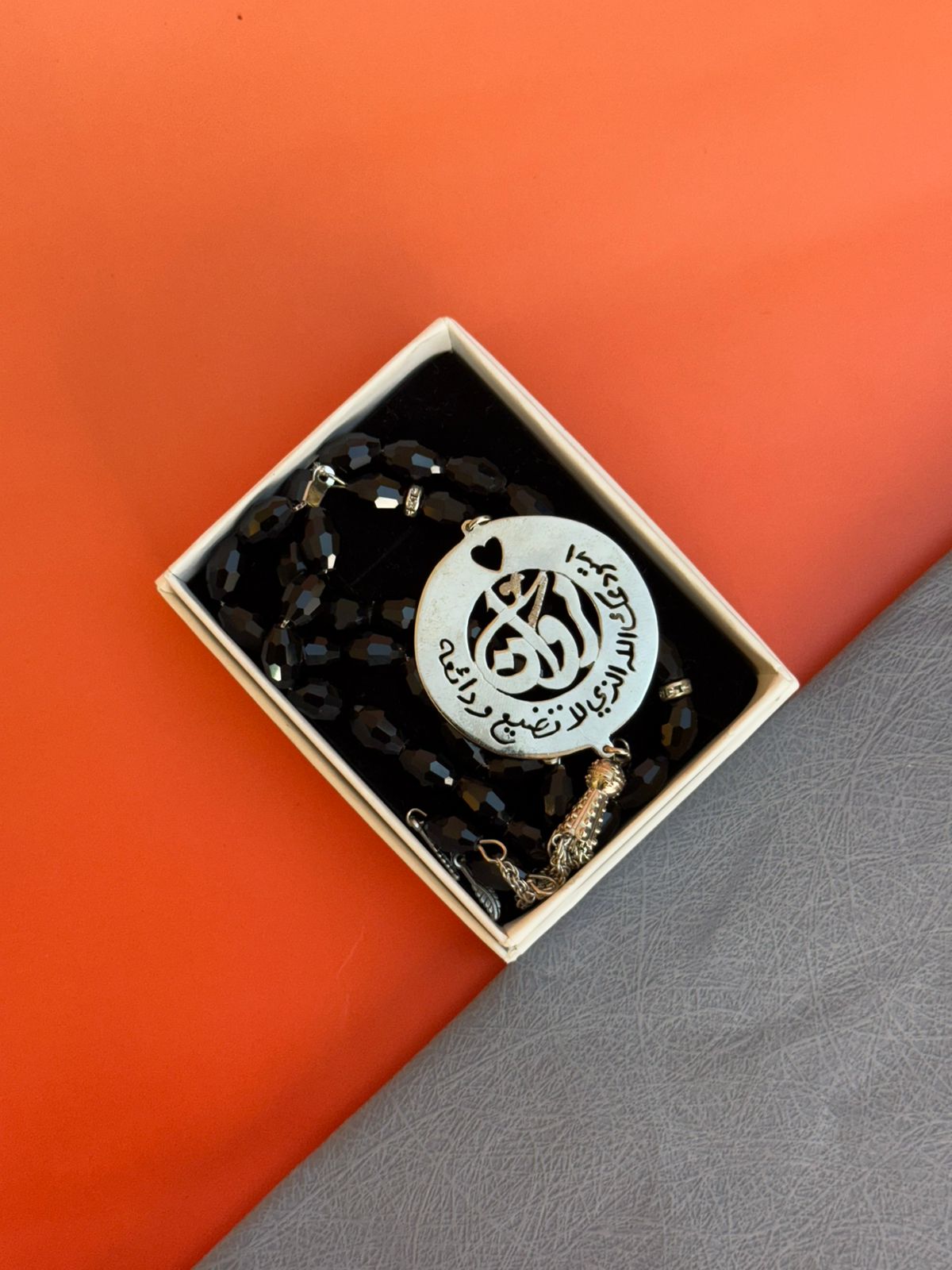 A Rosary with a religious phrase and laser engraving on the inside